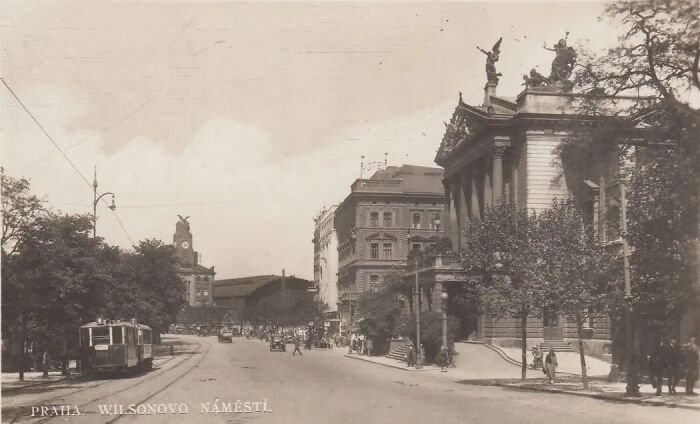 Historical photograph showing a street scene with vintage tram and classical buildings from 100 years ago.
