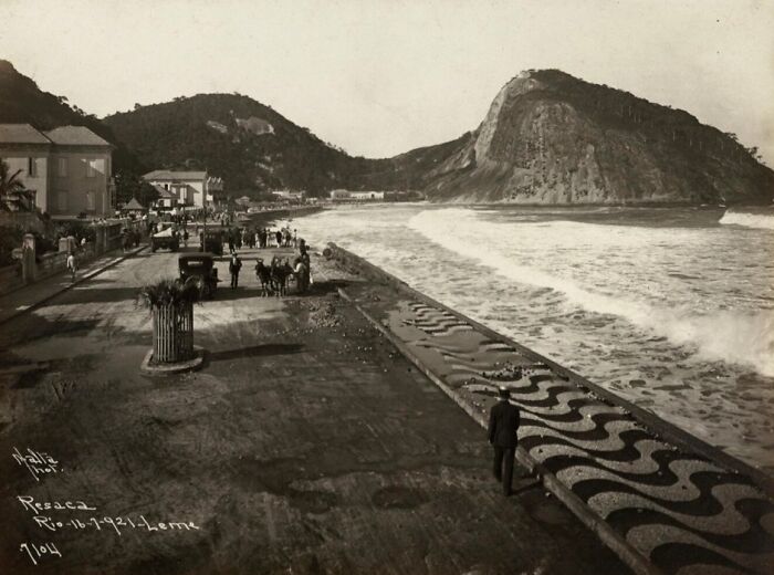 Historical photographs show a seaside promenade with people, horse-drawn carriages, and waves crashing along the shore.