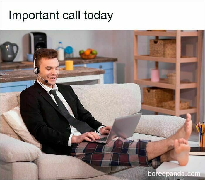 Man wearing a suit jacket and plaid pajama pants on a couch working on laptop, illustrating funny WFH memes about no real pants.