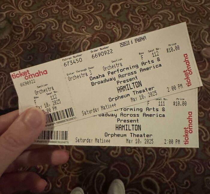 Hand holding two Hamilton theater tickets for May 10, 2025, showing unbelievable luck with last-minute seat availability.