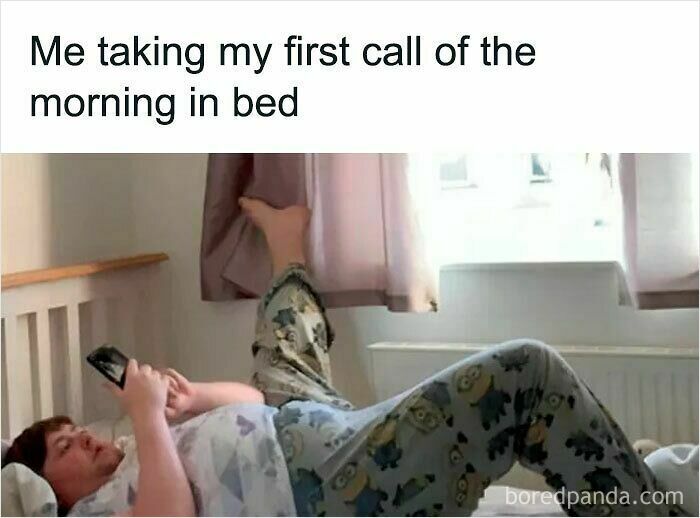 Person in pajamas lying in bed using phone, illustrating funny WFH memes about working without real pants since 2020.