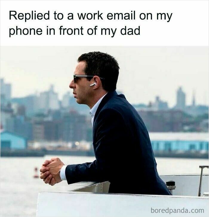 Man in sunglasses and earbuds replying to work email on phone, illustrating funny WFH memes about working from home.
