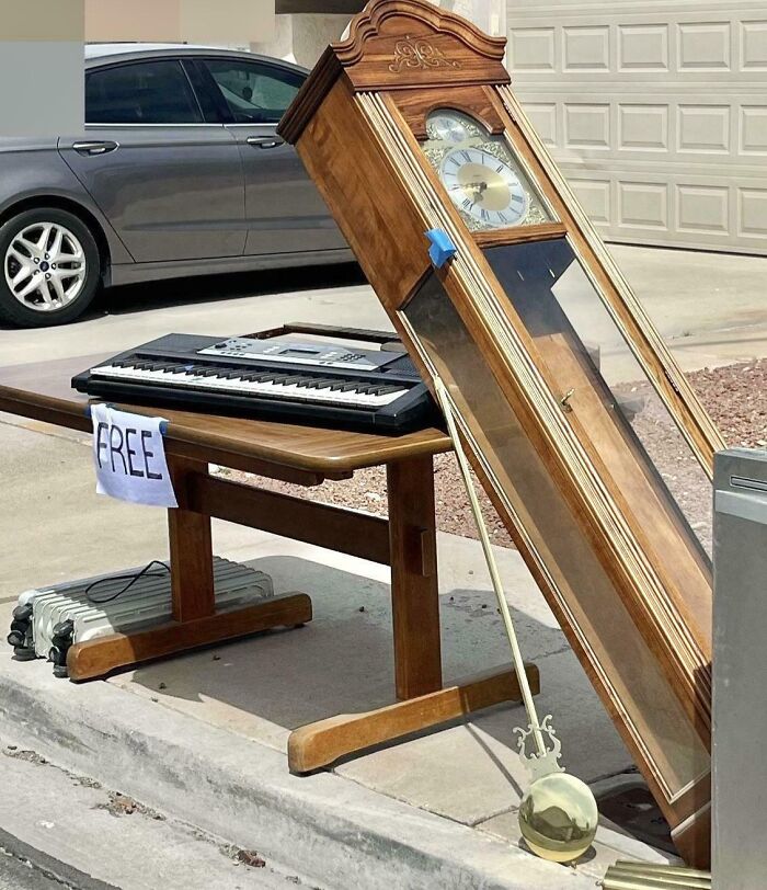 Grandfather clock and keyboard left on curb with free sign, capturing amazing photos of people experiencing unbelievable luck.