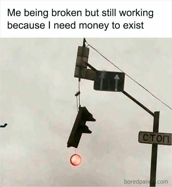 Traffic light hanging oddly with red light on, humorous work from home meme about struggling but still working for money.