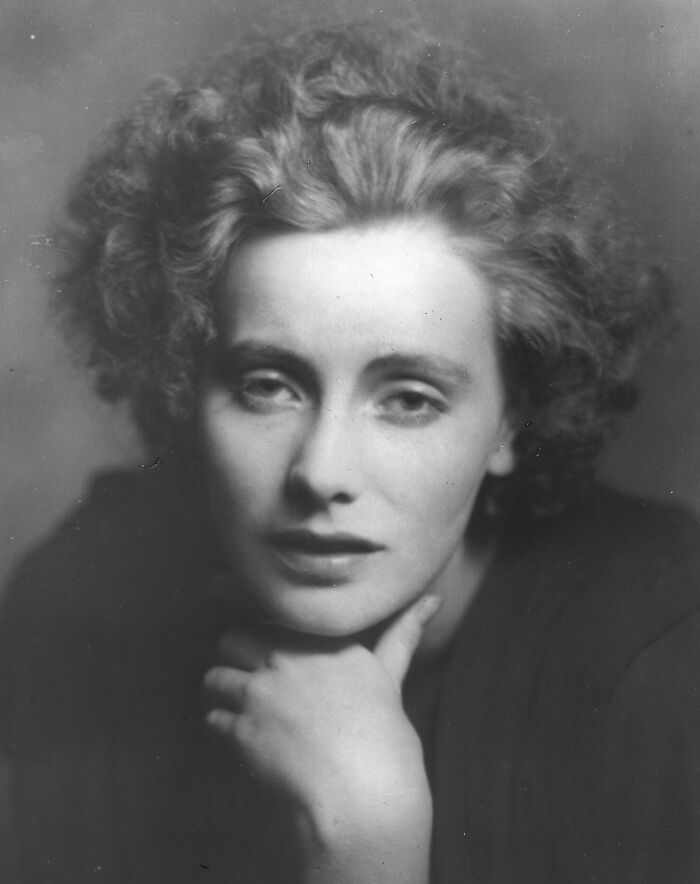 Black and white portrait of a woman from a century-old photo capturing timeless beauty and classic elegance.