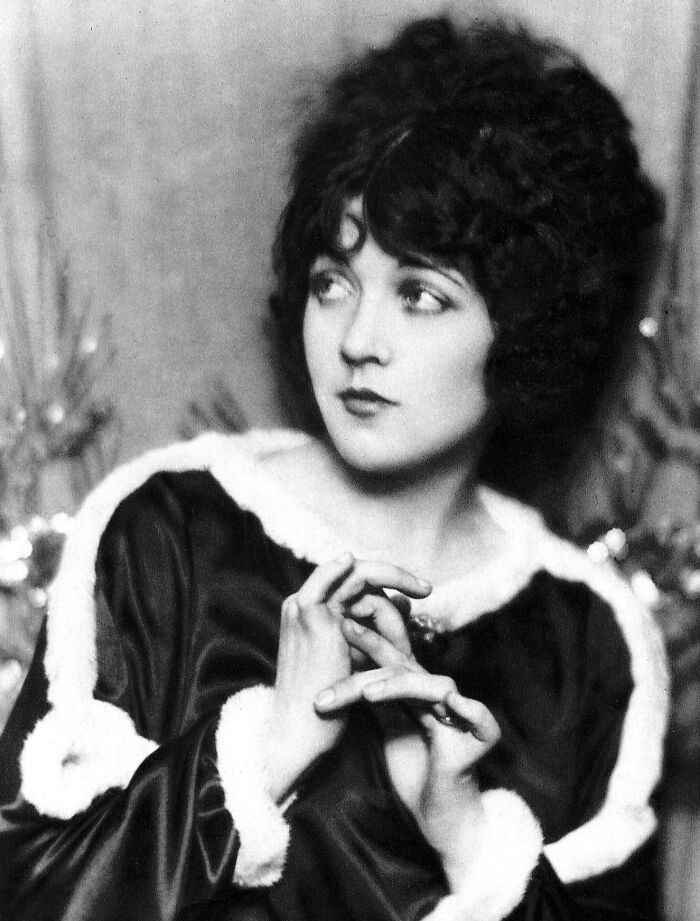 Black and white photo of a woman from century-old photos of the women who defined timeless beauty.