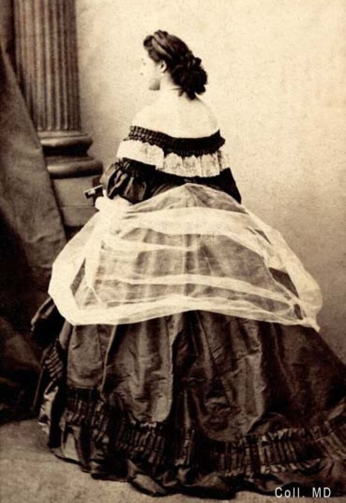 Victorian woman dressed in a voluminous gown, representing courtesans who became influential power players in history.