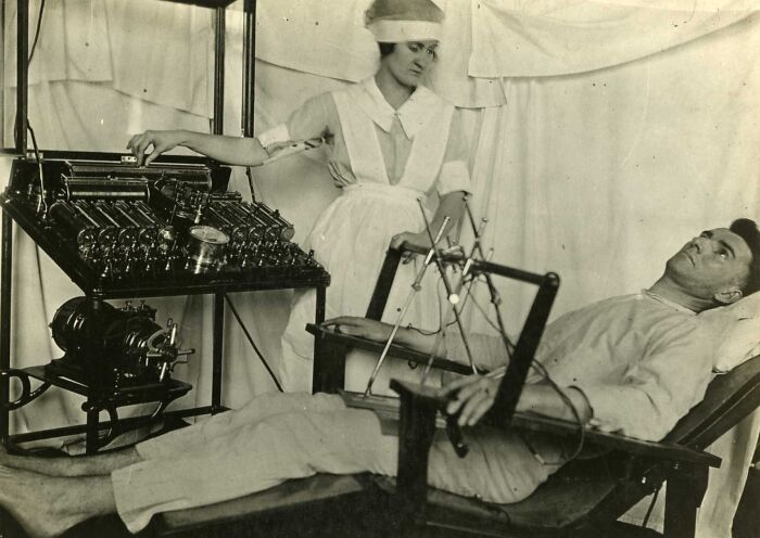 Vintage medical device in use with nurse and patient, showcasing unsettling medical technology from the past.