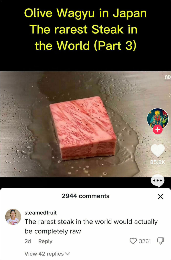 Square piece of rare Olive Wagyu steak cooking on a hot surface with internet comment on steak doneness visible