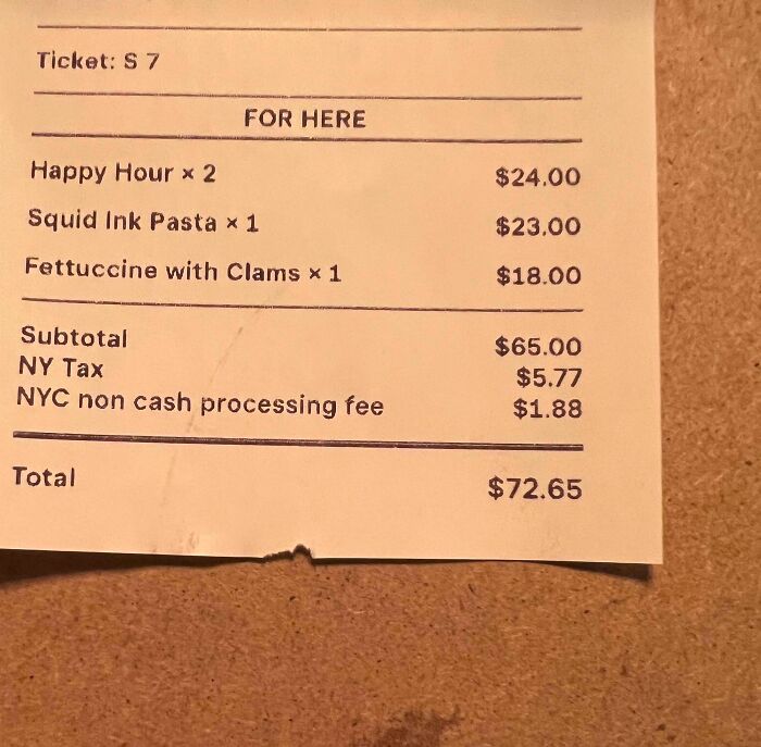 Receipt showing a non cash processing fee added to a restaurant bill, highlighting ridiculous fees people disliked.