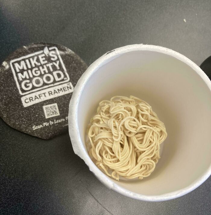 Instant ramen noodles in a cup with Mike's Mighty Good craft ramen lid, highlighting schools with unequal food options.