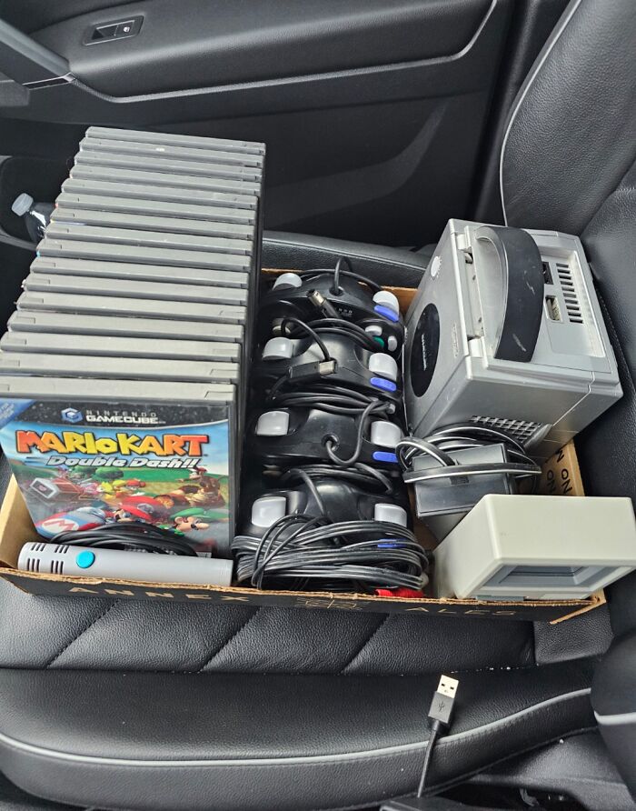 Box of vintage Nintendo GameCube console, multiple controllers, and game discs showcasing amazing photos of unbelievable luck.