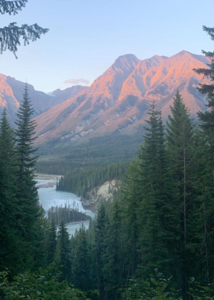 Scenic mountain landscape with pine trees and a winding river, capturing the essence of unbelievable luck in nature.
