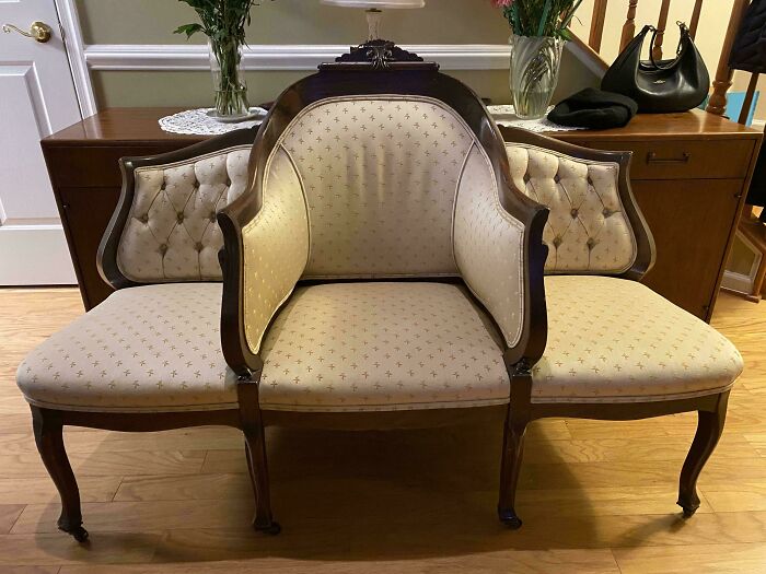 Elegant vintage wooden chair with upholstered cushions and floral patterns, showcasing beautiful old things people enjoy owning.