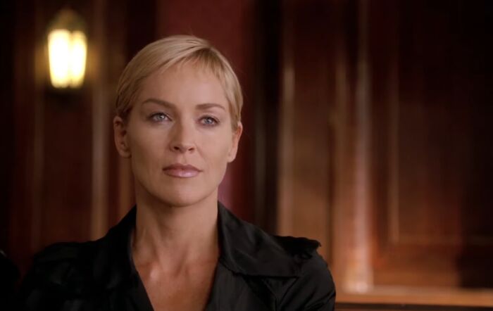 Actress with short blonde hair in a dark outfit, representing cinematic crimes in the worst movie sequels of all time.