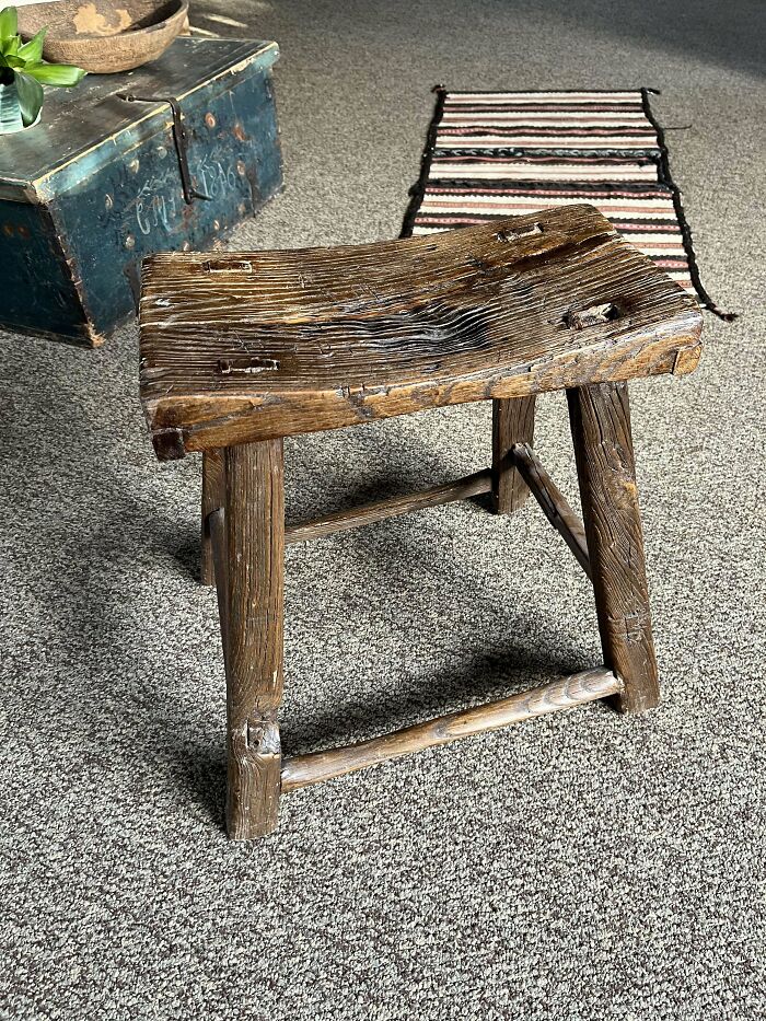 Rustic old wooden stool showing beautiful worn texture, one of the most interesting and beautiful old things people own.