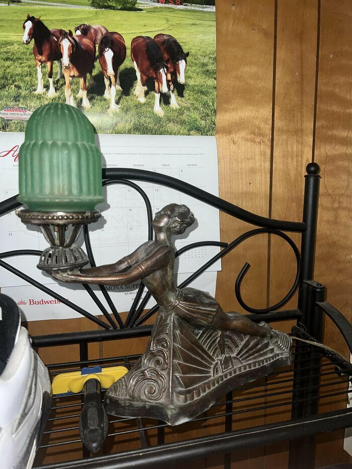 Antique decorative lamp with green glass shade and metal dancer figurine base showcasing beautiful old things collection.