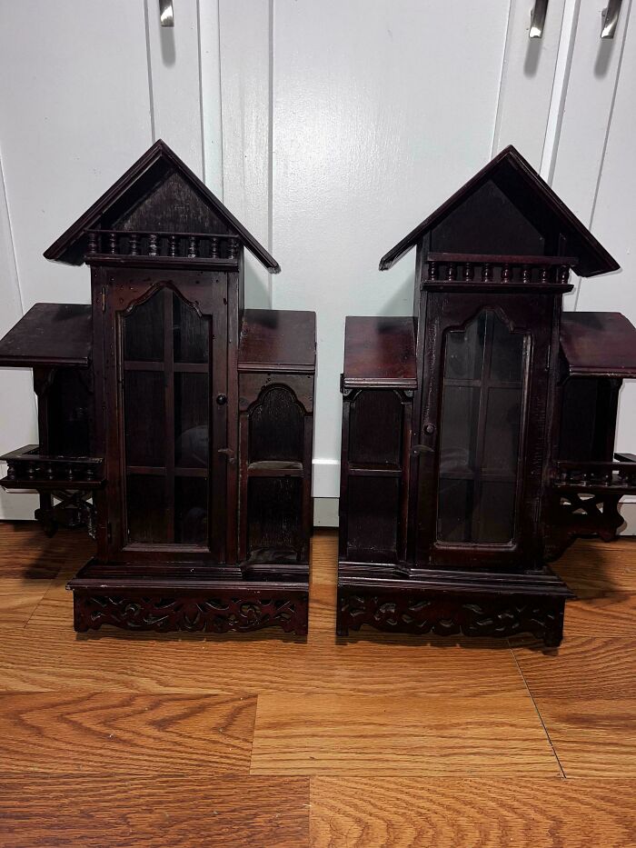 Pair of beautiful old wooden miniature cabinets with intricate carvings and glass-front doors on a hardwood floor.