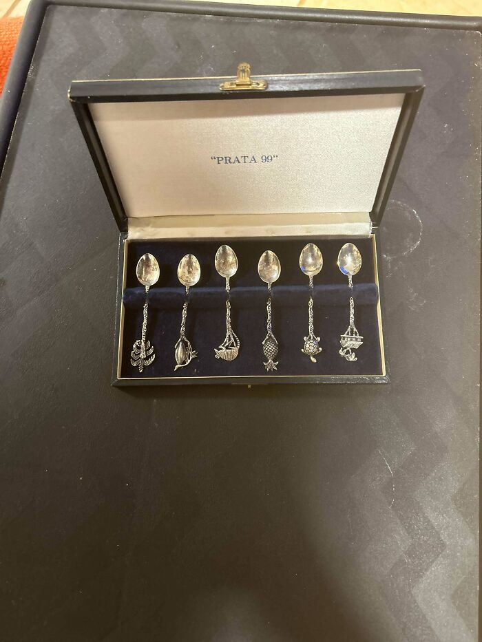 Set of six beautiful old silver spoons with intricate handles displayed in a velvet-lined vintage box, collectible old things.