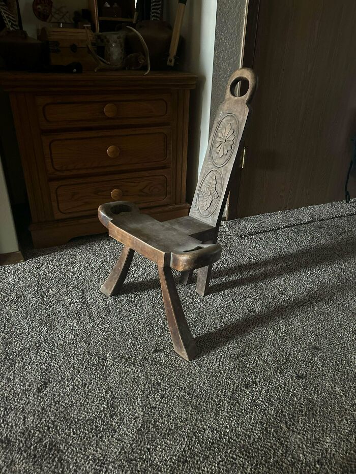 Antique wooden chair with carved floral designs, a unique old thing cherished by collectors and owners.