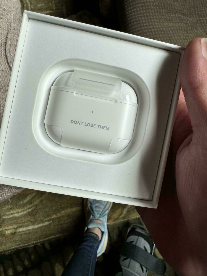 White wireless earbuds case in a box with text dont lose them, highlighting funny unfortunate situations of forgetting items.