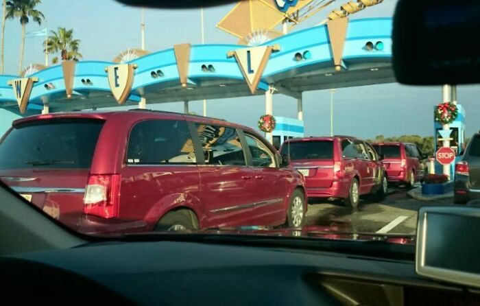 Multiple identical red SUVs lined up under a welcome sign, showcasing a real-life glitch in the matrix moment.