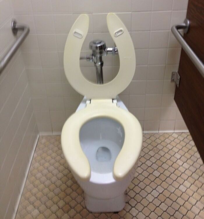 Toilet with two identical seats stacked, creating a glitch in the matrix effect seen in real life documented photo.