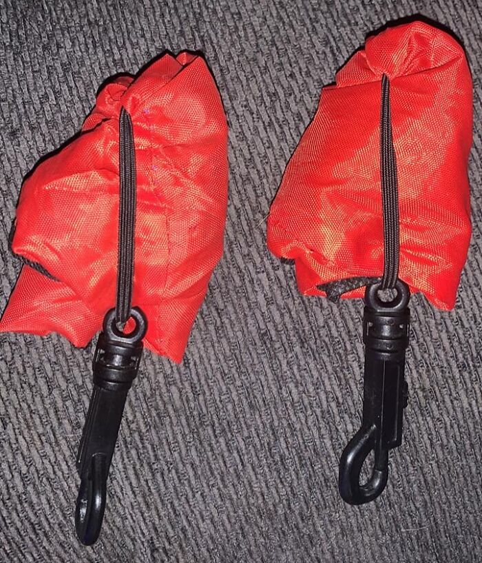 Two identical red fabric items with black clips, showcasing a real-life glitch in the matrix moment noticed by people.
