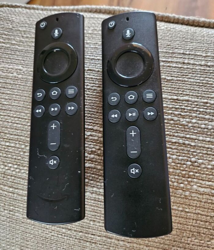 Two identical black remote controls side by side showing a real-life glitch in the matrix moment.