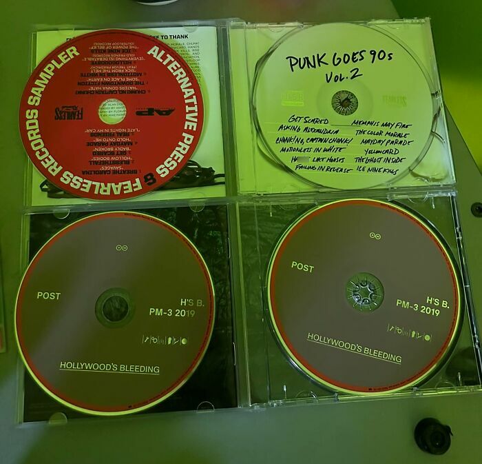 Four CDs in cases, including alternative press and punk 90s, showing real-life glitches in the matrix details.