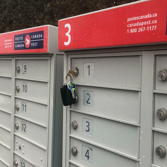 Canada Post mailboxes with keys accidentally left hanging on the lock, showing a funny unfortunate situation of forgotten items.