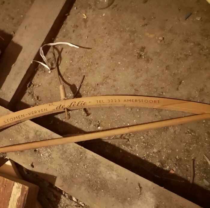 Old wooden bow found under floorboards in an old home, part of exciting and bamboozling home discoveries.