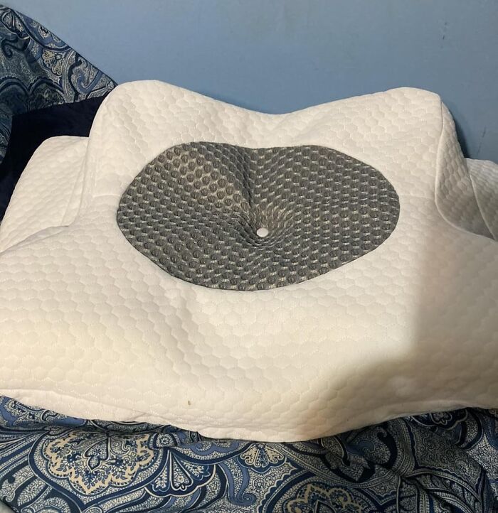 Memory foam pillow with ergonomic design and ventilation, a popular infomercial find watched on sick days.