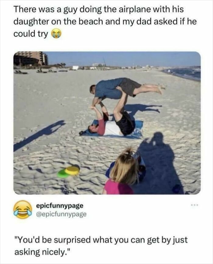 Man lying on beach lifting another man in airplane pose, showing suspiciously unbothered attitude and playful mood.