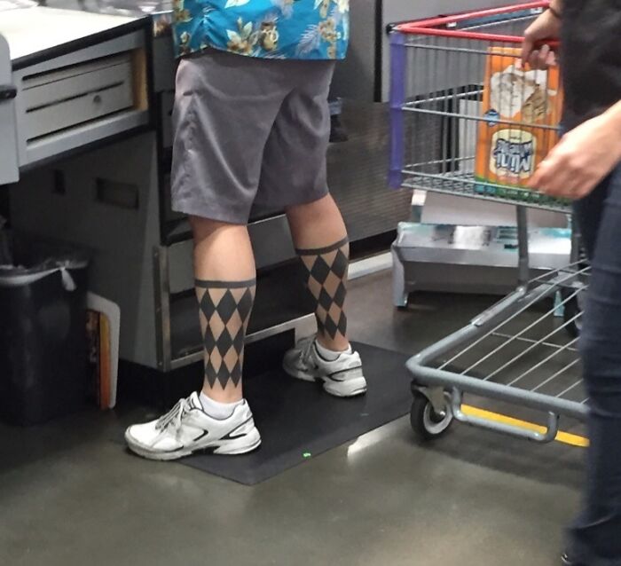 Person at checkout with diamond-patterned socks and white sneakers, showing a suspiciously unbothered attitude.
