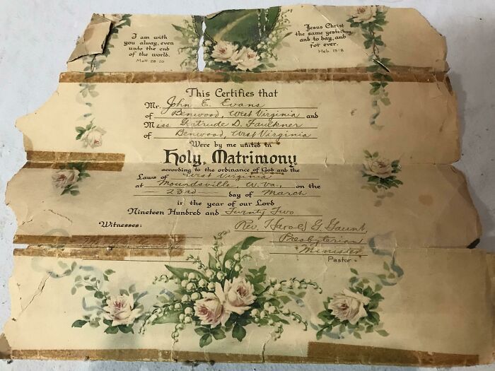 A worn vintage marriage certificate found under floor boards, featuring floral designs and handwritten details.