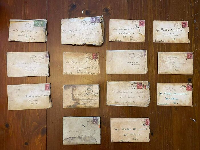 Collection of old, weathered envelopes found under floorboards in an old home during a fossil discovery.