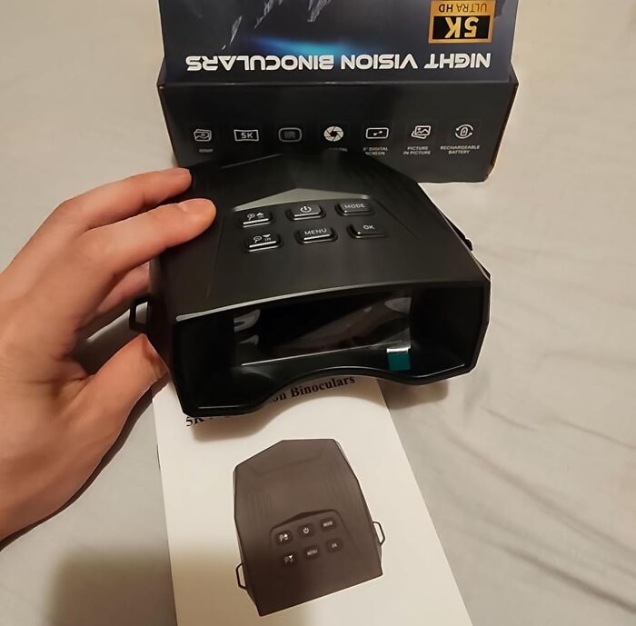 Hand holding 5K night vision binoculars with control buttons and packaging, a cool gift idea for last-minute panic.