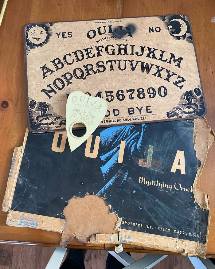 Vintage Ouija board and planchette found under old floor boards, a mysterious discovery in an old home.
