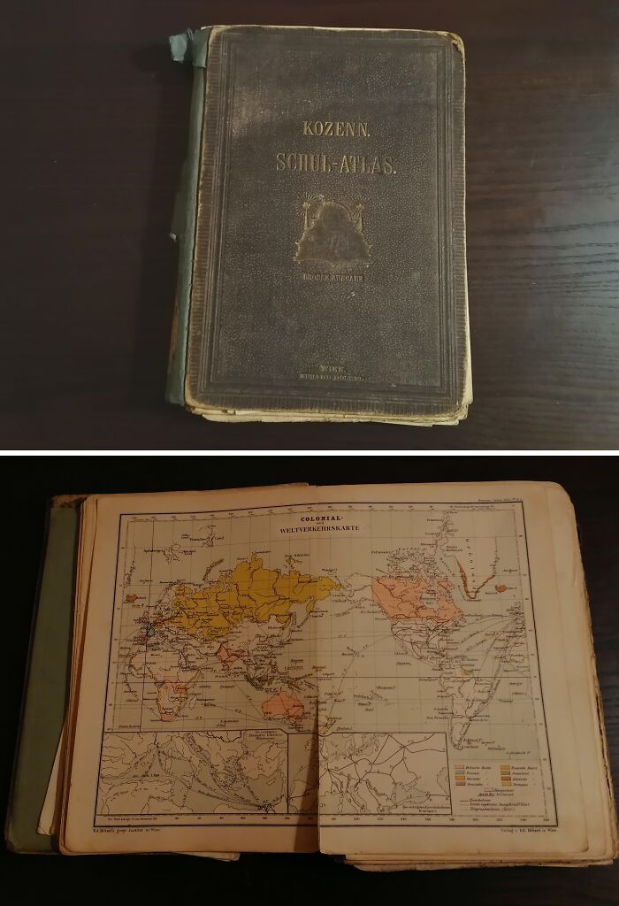 Old vintage atlas book found under the floor boards in an old home, showing colonial maps and aged pages.
