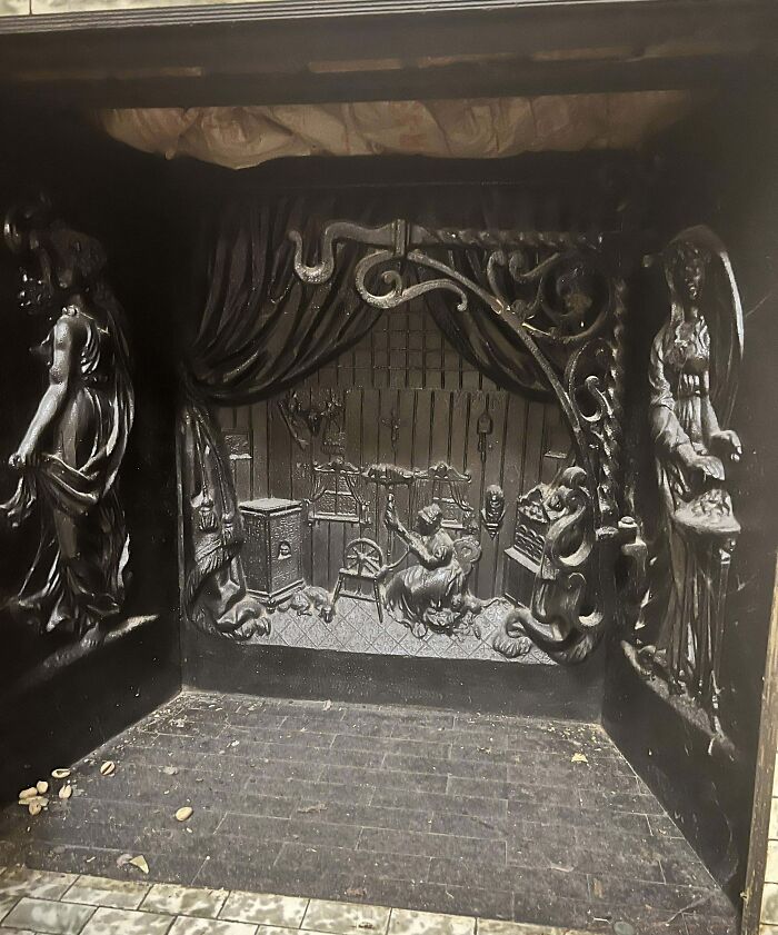 Intricate fossil under the floorboards depicting detailed figures and scenes inside an old home setting.