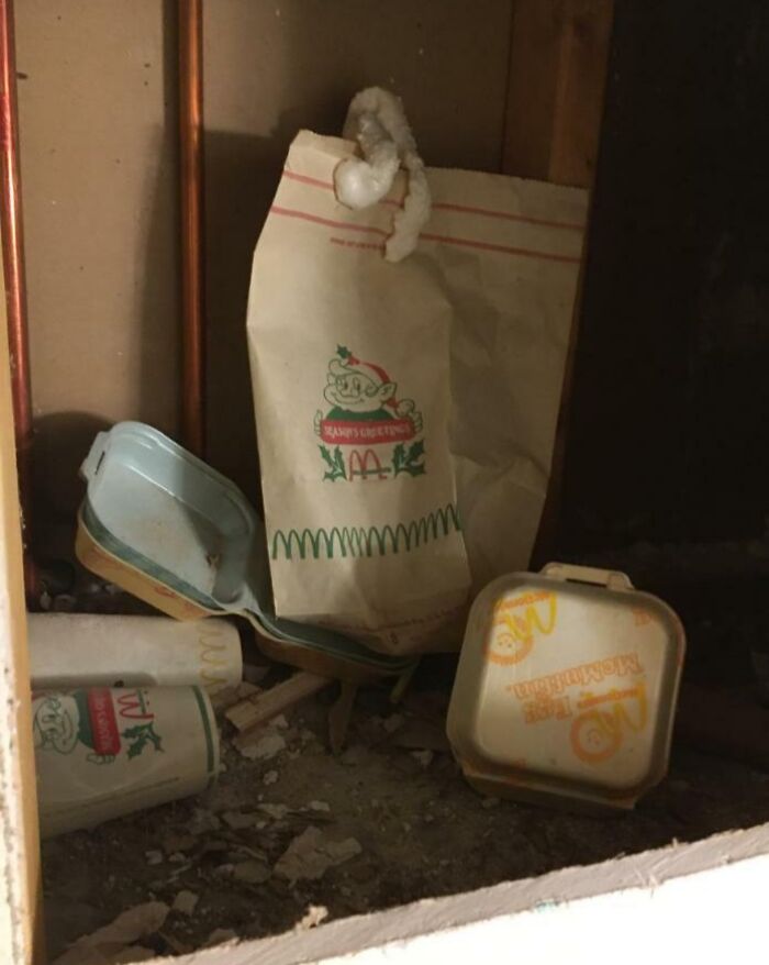 Old McDonald's holiday packaging and containers found hidden under floorboards in an old home discovery.