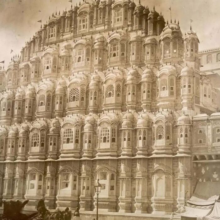 Historic old architecture featuring intricate windows and ornate balconies on a grand multi-story building facade.
