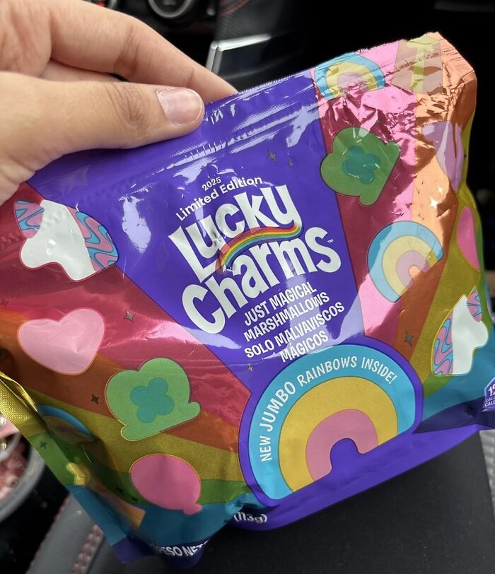 Hand holding limited edition Lucky Charms with magical marshmallows, a quirky Amazon weird pick with jumbo rainbows.
