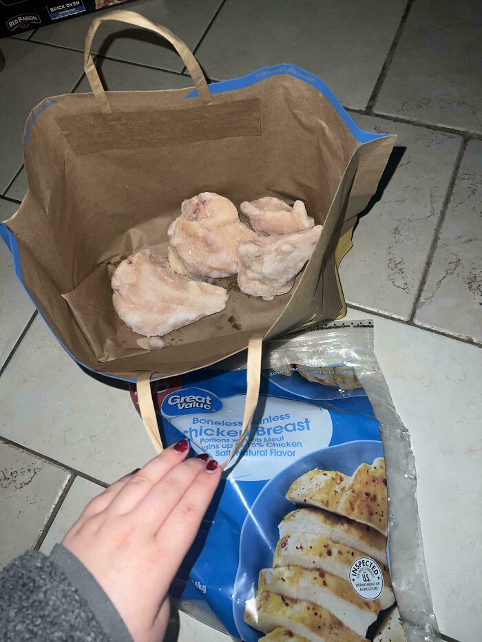Frozen chicken breast partially unpacked inside a bag, showing a delivery that went totally off track and off brand expectations.