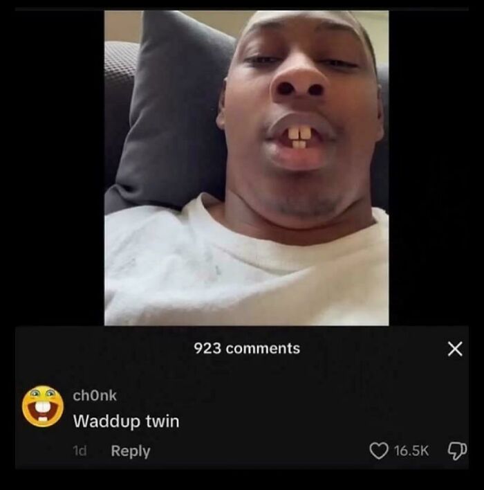 Man with gap teeth lying on a couch, internet comment humorously calling him twin, showcasing weird internet moments.