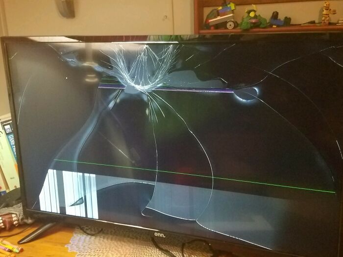 C*****d and broken TV screen with visible damage lines, illustrating a delivery gone wrong or package mishap.