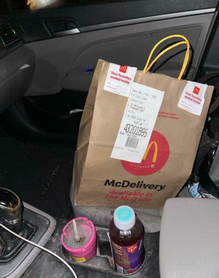 McDelivery package placed inside a car, showing a takeout order bag as part of delivery and package off track stories.