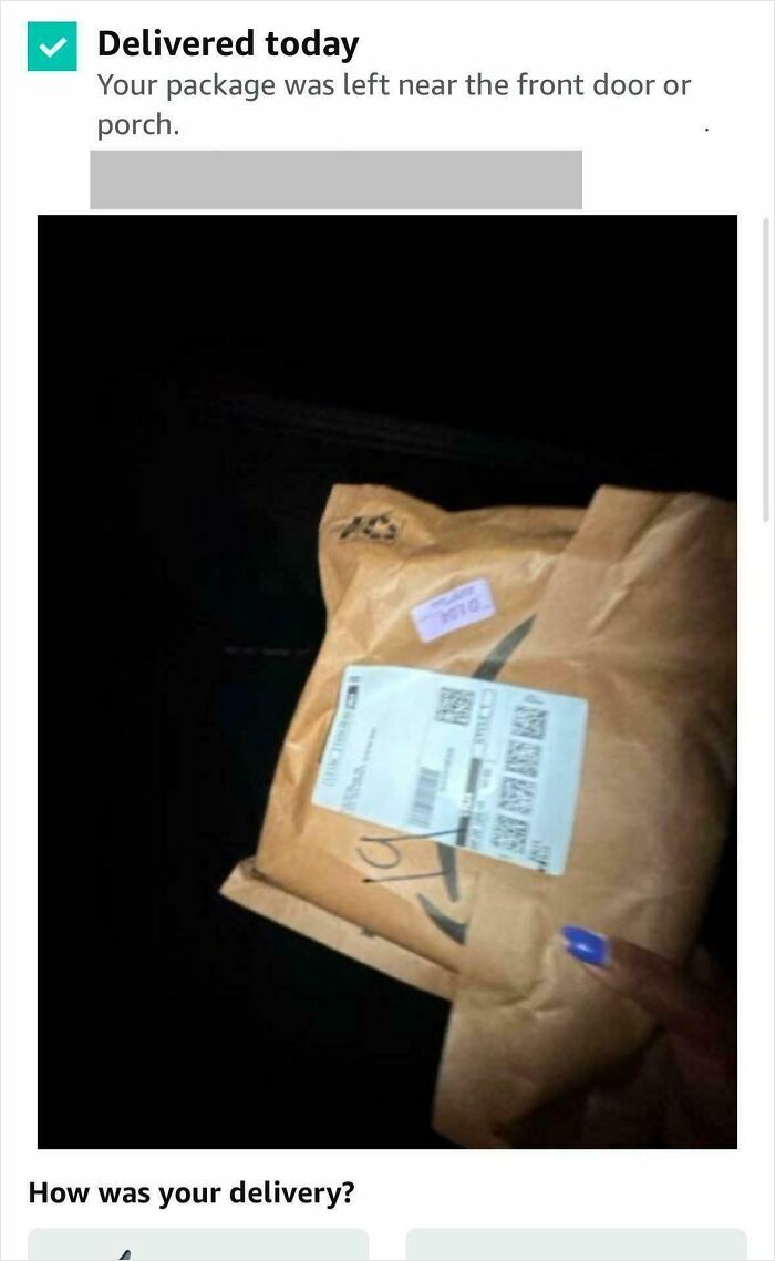 Package delivery confirmation showing a brown package held by a person with blue nail polish, highlighting delivery tracking details.
