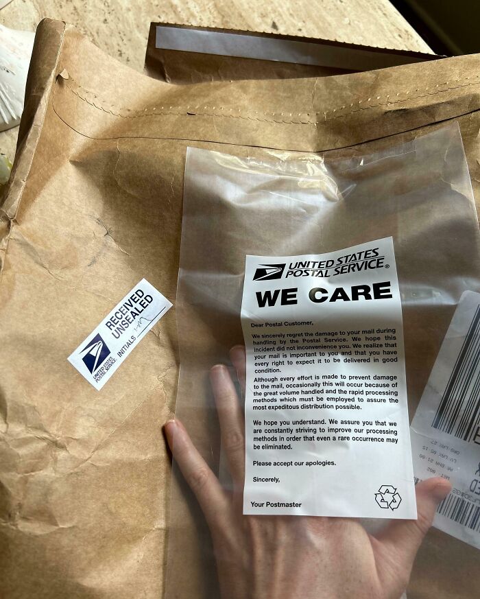 Damaged package with a United States Postal Service note explaining delivery issues and care taken with mail handling.